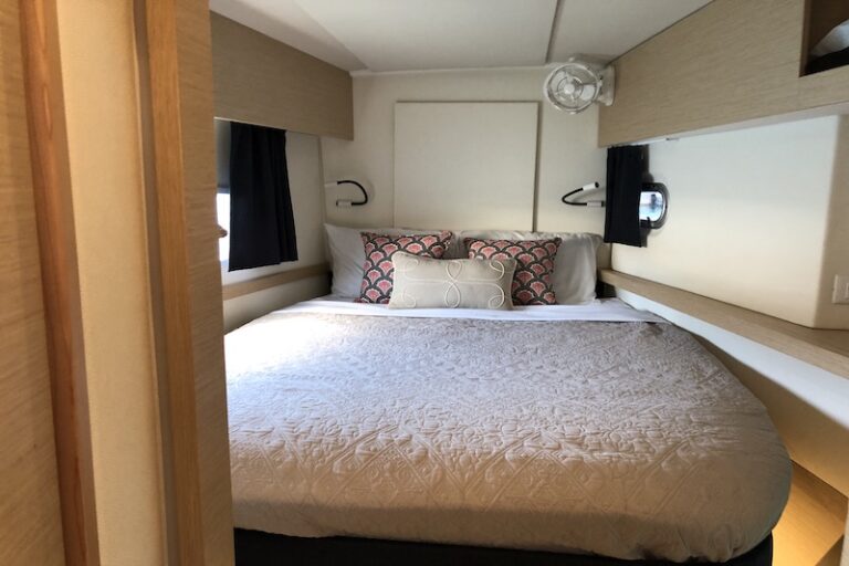 A bed inside a sleeping cabin aboard the Eddies in Time yacht, part of the &Beyond Yacht Charters fleet