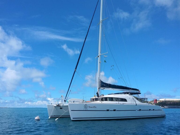 Dreamcatcher yacht is anchored in blue open waters, part of the &Beyond Yacht Charters fleet